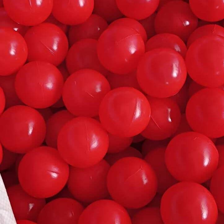 Open bulk bag of red play balls
