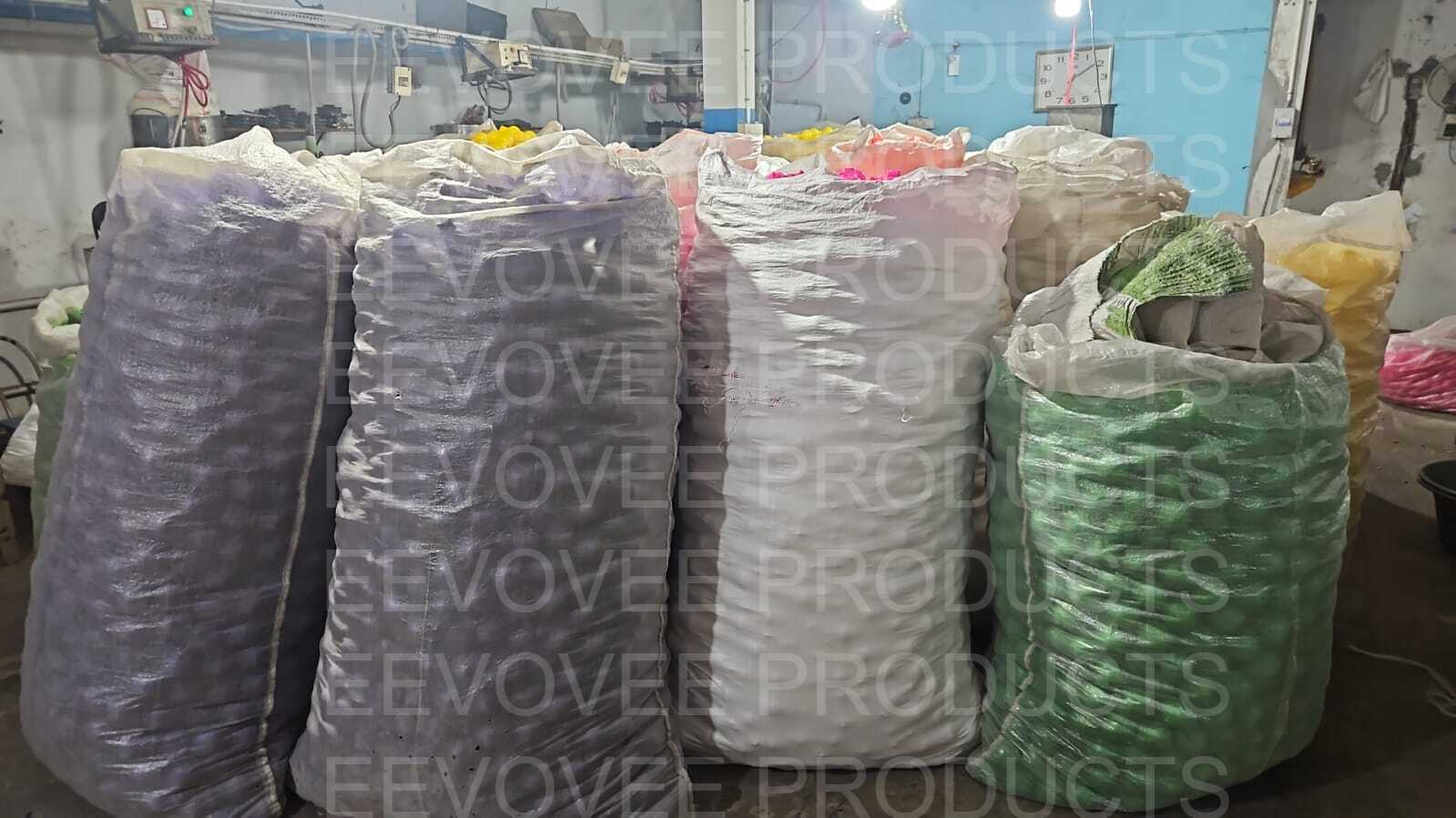 Warehouse storage area with stacked bags of finished play balls